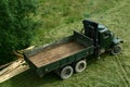 Old green army truck modified for timber transport