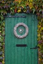 Old green barndoor surrounded by ivy Royalty Free Stock Photo