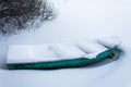 An old green boat in a frozen lake. Boat covered with pure snow Royalty Free Stock Photo