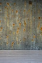 Old green brown surface and concrete wall with rusted spots on white wooden floor Royalty Free Stock Photo