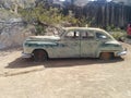 Old green Chrysler car in the desert Royalty Free Stock Photo