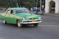 Old Green Classic Car driving by, Havana, Cuba Royalty Free Stock Photo