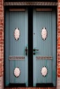 Old , green decorated front doors - brick wall Royalty Free Stock Photo