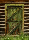 Old Green door on a old log cabin .