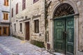 Old doors with peeled off paint in an old stone town