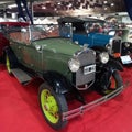 Old green 1930 Ford Model A double Phaeton convertible on red carpet. Exhibit hall. Classic car show Royalty Free Stock Photo