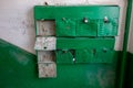 Old green mailboxes in a dirty staircase in Russia