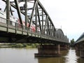 Old Green Metal Railroad Bridge with Red Train Crossing River Royalty Free Stock Photo