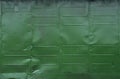 Old green metal wall. The texture of the sheets of colored iron Royalty Free Stock Photo