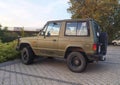 Old green offroad 4WD car Mitsubishi Pajero parked