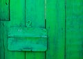 Old green painted wood door with number two and mail hole with steel cap Royalty Free Stock Photo