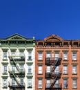 Old green and red apartment buildings with empty clear blue sky background in the Alphabet City neighborhood of Manhattan in New