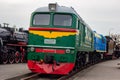 Old green and red diesel engine locomotive at the railway station. Vintage train staying on the railroad. Royalty Free Stock Photo