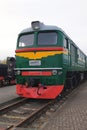 Old green and red diesel engine locomotive at the railway station. Vintage train staying on the railroad. Royalty Free Stock Photo