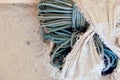 Old green rope in broken white bag with copy space Royalty Free Stock Photo