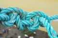 Old green rope knotted on a yellow background. Knot. Insoluble problem concept