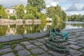 Old, green rope lies on rocky street by river. Royalty Free Stock Photo