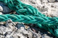 Old green rope shot against stone background Royalty Free Stock Photo
