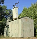 The old green rural electric distributive transformer in forest Royalty Free Stock Photo