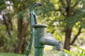 An old rusty garden pump out of order in the garden Royalty Free Stock Photo