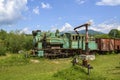 Old green steam locomotive train stands on narrow-gauge railway in Kolochava