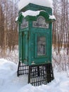 Old telephone box in forest under snow Royalty Free Stock Photo