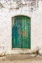 Old green timber door in the scuffed wall Royalty Free Stock Photo