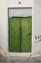 Old green timber door in the scuffed wall Royalty Free Stock Photo