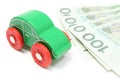 Old green toy car with money on white background Royalty Free Stock Photo