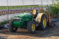 old green tractor near the greenhouse 1 Royalty Free Stock Photo