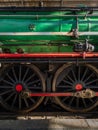 Old green train wagon wheels closeup