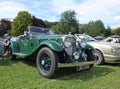 An old green vintage bentley open top touring car with people in the background at the Annual Hebden Bridge Vintage Weekend Vehicl