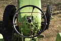Old green vintage tractor stands on farm yard Royalty Free Stock Photo