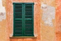 Old green window shutter and rustic wall of mediterranean house Royalty Free Stock Photo