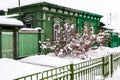 Old green wodden house in cloudy winter day in ancient Russian town