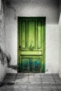 Old green wooden door with wrought iron door details Royalty Free Stock Photo