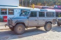 Big dusty grey 4wd allroad car Land Rover parked