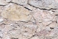 Old grey and brown rough stone wall, closeup texture background, selective focus, shallow DOF Royalty Free Stock Photo