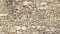 Old grey and brown rough stone wall, closeup texture background, selective focus, shallow DOF Royalty Free Stock Photo