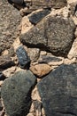 Old grey and brown rough stone wall, closeup texture background, selective focus, shallow DOF Royalty Free Stock Photo