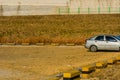 Old grey car in a public parking lot Royalty Free Stock Photo