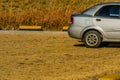 Old grey car in a public parking lot Royalty Free Stock Photo