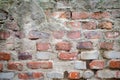 Old grey concrete garage wall with red bricks and cracks background Royalty Free Stock Photo