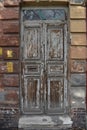 old grey door with stripped paint and wooden texture vintage retro Royalty Free Stock Photo