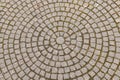 Old grey pavement of cobble stones in a circle pattern in an old medieval european town Royalty Free Stock Photo