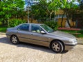 Old grey Peugeot 406 private car sedan parked right side front view