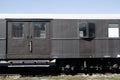 Old grey retro vintage wagon standing on the rails on the background of blue sky Royalty Free Stock Photo