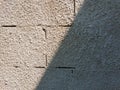 Old grey stone masonry wall texture made of foam blocks or airblocks split on two sides light and shadow. Abstract plastered