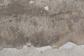 Old grey stucco wall with cracked plaster. Background texture Royalty Free Stock Photo