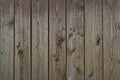 Old grey weathered outside wall of rustic barn covered with vertical worn wooden planks for texture or background. Royalty Free Stock Photo